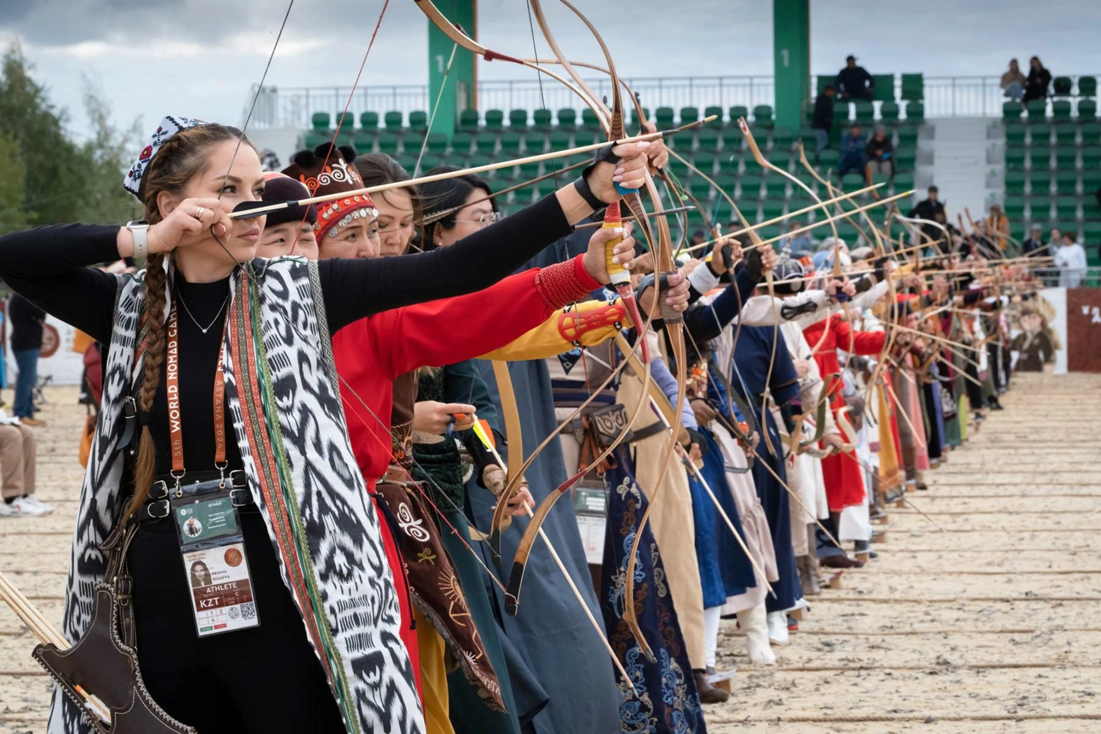 Archers in traditional attire aiming together